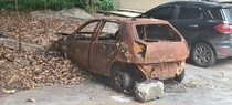 Abandoned and burned car in Copacabana Rio Brazil