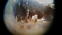 Abandoned boarding house of Winter Quarters Utah through binoculars