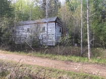 Abandoned building next to an abandoned railroad grade timber boom region of Michigans upper peninsula
