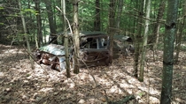 Abandoned classic car along an abandoned railroad bed in north east PA