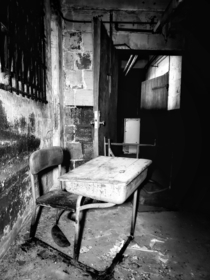 Abandoned desk in decaying reform school
