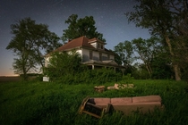 Abandoned farmhouse in rural western Iowa Photographed around midnight during a crescent moon