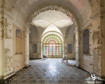 Abandoned Italian Manicomio Madhouse psychiatric hospital entrance hallway with wheelchairs 