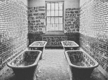 Abandoned mental hospital room with graffiti 