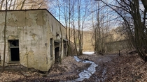 Abandoned miners housing under a forest partially flooded