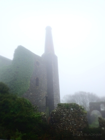Abandoned tin mine in Cornwall UK on a very grey and misty day 