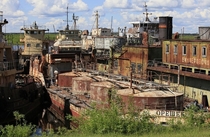 Abandoned towboats and barges in a port on the Yenisei River in Siberia 