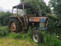 Abandoned tractor by old farm 