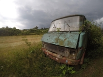 Abandoned truck on a german field in front of an upcoming thunderstorm