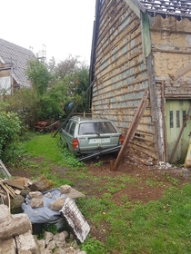 Abandoned Volkswagen Passat next to an nearly collapsed house Roetgen -Germany
