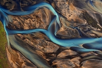 Aerial shot of a river splitting in Iceland by Emmanuel Coupe 