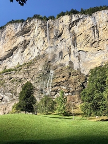 Almost  tall Staubbach waterfall Lauterbrunnen Switzerland Cow in bottom right for scale 