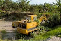 An abandoned excavator by the side of a river Mexico 