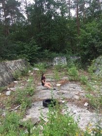 An abandoned swimming pool in the middle of a forest