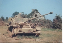 An abandoned Tiger tank sits incapacitated 