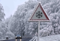 An ice warning sign encrusted with ice near Hessisch Lichtenau Germany Photo by Uwe Zucchi  x-post rRoadSignPorn