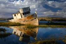 An old rusty ship in Tomales Bay California  by Gideon Chen