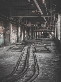 An old track system on the top floor of an abandoned auto plant