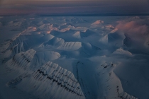 As the sun returns to the Arctic after dark winter rich light bounces off the mountaintops Photo by Paul Nicklen 