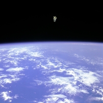 Astronaut Bruce McCandless II floats untethered away from the safety of the space shuttle with nothing but his Manned Maneuvering Unit keeping him alive The first person in history to do so
