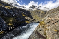 At the crest of Bowmar Falls Fiordland National Park NZ looking across to the Earl Mountains 