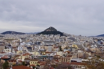 Athens Greece Just and endless ocean of buildings with a few ancient ruins scattered here and there Feat Mount Lycabettus