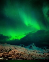 Aurora Borealis above snow covered Lofoten Peaks Lofoten Islands Norway OC x