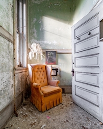 Beautiful chair and shredded lamp shade found in abandoned mansion
