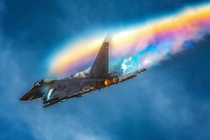 Beautiful sky The Typhoon jet flown produced a rainbow effect The rainbow is made of crystalized water vapor that reflect and refract sunlight causing the rainbow effect