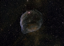Blown by fast winds from a hot massive star this cosmic bubble is huge Cataloged as Sharpless - it lies some  light-years away toward the constellation of the Big Dog Canis Major and covers slightly more of the sky than a Full Moon 