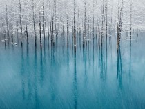 Blue pond and first snow Hokkaido Japan 