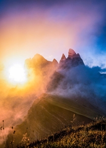 Breaking through the clouds at sunrise Seceda Italy 