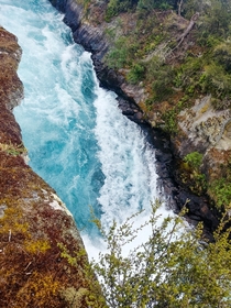 Bright blue waters of the Waikato River churning on their way to Huka Falls NZ 