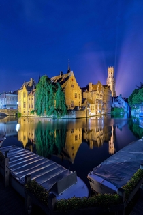 Bruges at night reflected in the canals 