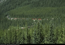 Canadian Pacific train passes over itself in the lower spiral tunnel in the Rocky Mountains of eastern BC The upper spiral tunnel is directly above and behind the photographer 