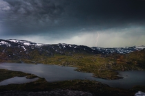 Captured lightning between tunnels on the Oslo to Bergen train overlooking Nedra Grndalsvatnet just past Hallingskeid Norway 