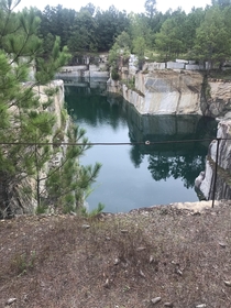 Closedabandoned granite quarry This one goes down about - feet and has all sorts of old equipment and junk in it