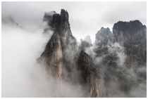 Clouds engulfing peaks at Huangshan Yellow Mountains Anhui China 