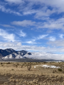 clouds over new mexico snowy mountains