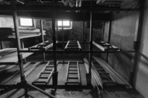 Coffin storage racks in the basement of a vacant funeral home OC -   