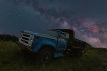 Composite of a truck under the Milky Way 