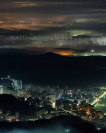 Continuing layers of mountains and cityscape shrouded in fog around the border between Seoul and the surrounding Gyeonggi Province South Korea