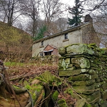 Cottage nestled against hill 