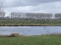 Cycle  walking bridge over the Amsterdam Rijn kanaal in the Netherlands near Nigtevecht To see the winding ramp the distance was needed and without the greens you can see it clearly This one is great fun to take on bike
