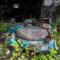 Decomposing car in the abandoned village of Rudki located  km west of Pripyat deep inside the Chernobyl Exclusion Zone 