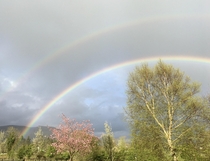 Double rainbow in NW Ireland Sort looks like the inner rainbow is trying to keep the cloudy sky away from the trees