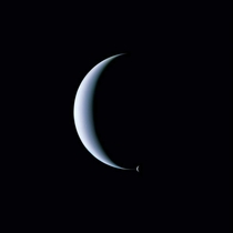 Dual crescent view of Neptune and its moon Triton one of the last images taken by Voyager  as it sped onwards to interstellar space