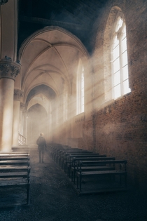 Early morning sun rays inside an abandoned church in Belgium