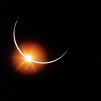 Earth eclipses the sun  an image captured on a mm camera by the Apollo  crew on their way home aboard Yankee Clipper