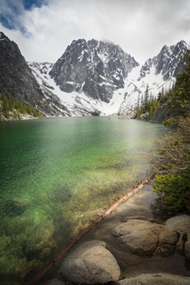 Emerald green water of Colchuk Lake with Dragon Tail peak  WA 